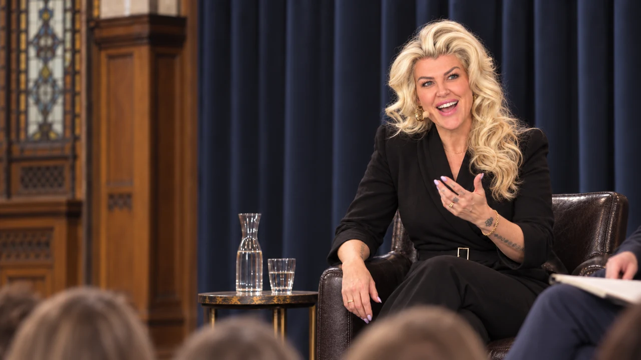 Penny Dee smiling while speaking on a panel